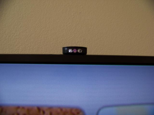 Stuck to top of TV with double stick tape.